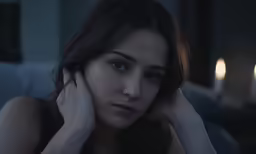 a woman looks tired while holding her hand on the face