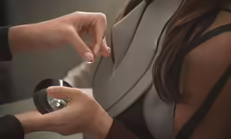 two people holding their hands and making a ring