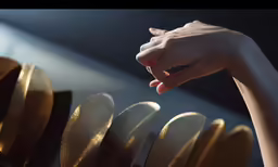 there are gold pieces being held by hands