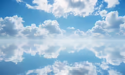 clouds reflecting on the calm blue water surface