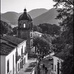 black and white image of people walking around a village