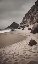 footprints on the sand at a beach near some hills