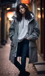 a woman posing for the camera wearing black jeans and a parka