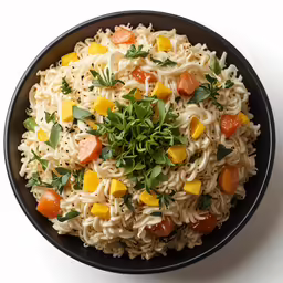 a bowl filled with noodles and carrots on a table