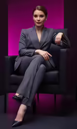 a young woman in black sitting on top of a chair