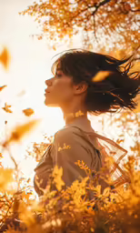 woman in a field looking back towards the sun