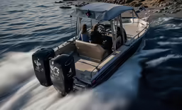 two people riding a boat in the water