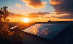 the sun is setting over a rooftop with a window