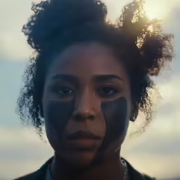 the woman has her face painted with black paint