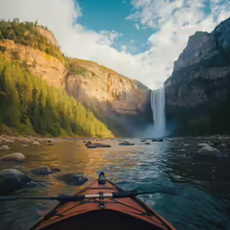the view from a kayak shows a waterfall and the shoreline