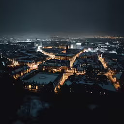 night time skyline with buildings lit up with streetlights and street lights