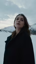 a woman standing on a snow covered field