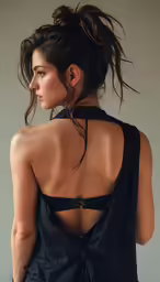 a young woman with a shaved back wearing a bra