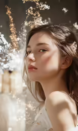 a young woman standing underneath lights in her hair