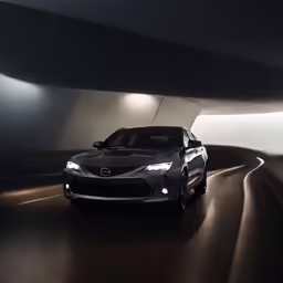 the black car driving through an empty tunnel
