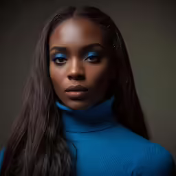 a young woman in blue and a ponytail