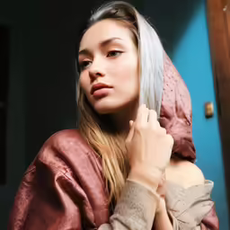 a woman with grey hair and a scarf on