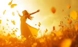 a beautiful woman standing in a field full of butterflies