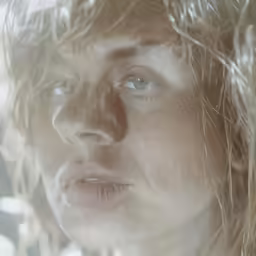 a woman with blonde hair looking into the distance