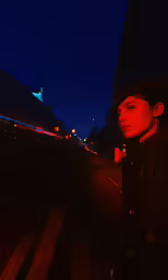 man in black jacket with fedora at night