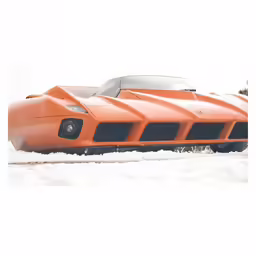an orange sports car is driving through the snow