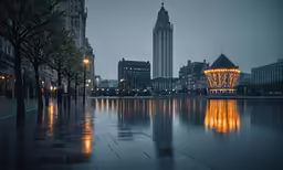 a clock tower that is shining on a building near a lake