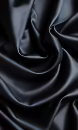 black fabric that is folded together on top of another material