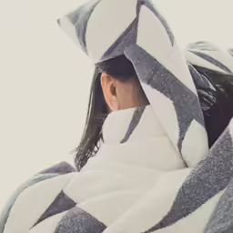 woman wrapped in towel wrapped up by the snow