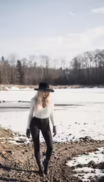 a woman in a black hat and some snow