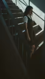 a woman standing at the bottom of stairs