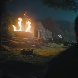 the fire is burning inside the small building
