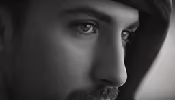 a black and white photo of a man with beard
