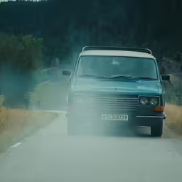 a van traveling on a road through the countryside