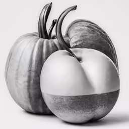 three different sized vegetables stacked together in a black and white photo