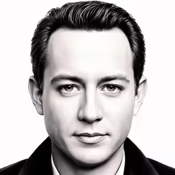 a black and white image of a man with a tie