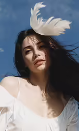 a woman standing with her hair in the wind