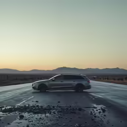 a car driving on the road at sunset