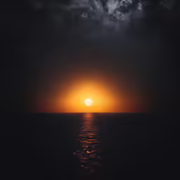 an image of the sun setting over the ocean