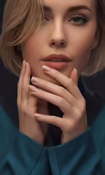 a beautiful blond with nails and a ring is standing
