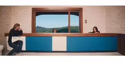 woman sitting at the counter looking out of the window