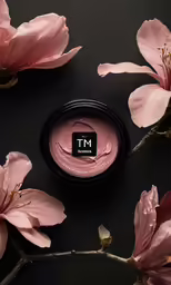a black container that has some pink flowers on it
