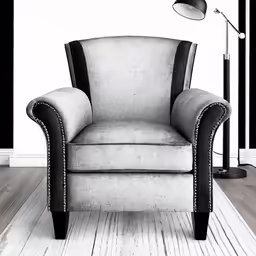 a chair and a floor lamp are in front of a large painting