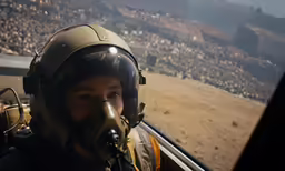 man with protective equipment looking out the window of his jet