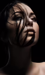 the woman has hair blowing down on her face