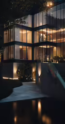 a glass building with bright lighting shining through the windows