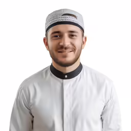 a man with beard smiling and wearing a white shirt