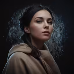 a woman wearing a cape and blowing hair
