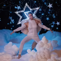 a woman in a white body suit holding a star