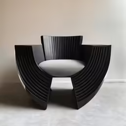 a small black chair that is sitting in the corner