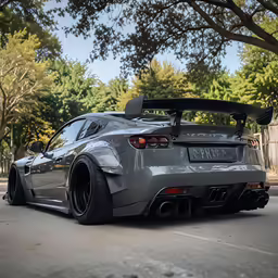 the grey sports car is parked in a parking lot